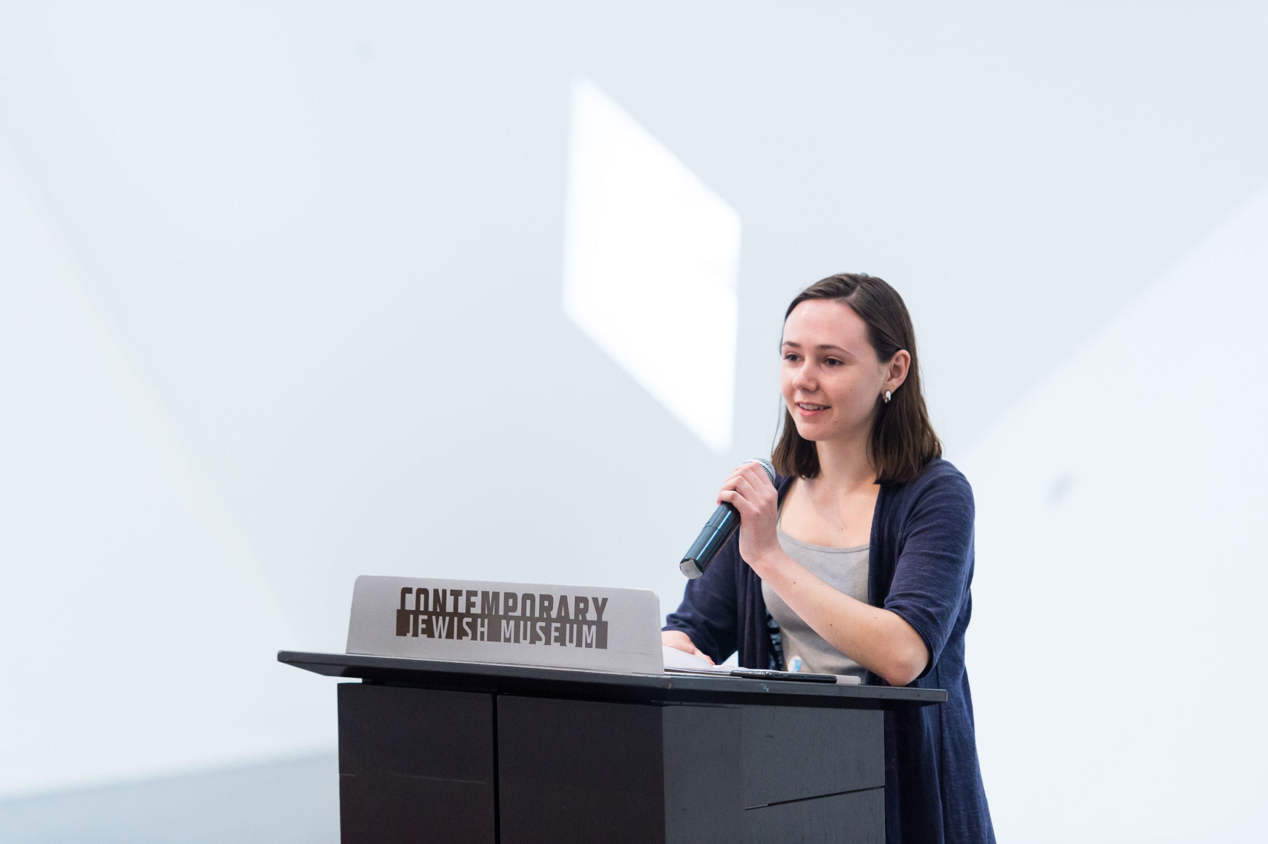 TAC squad member and <em>What We Hold</em> participant Elizabeth Levie speaks about her experience in creating audio stories at the opening reception.